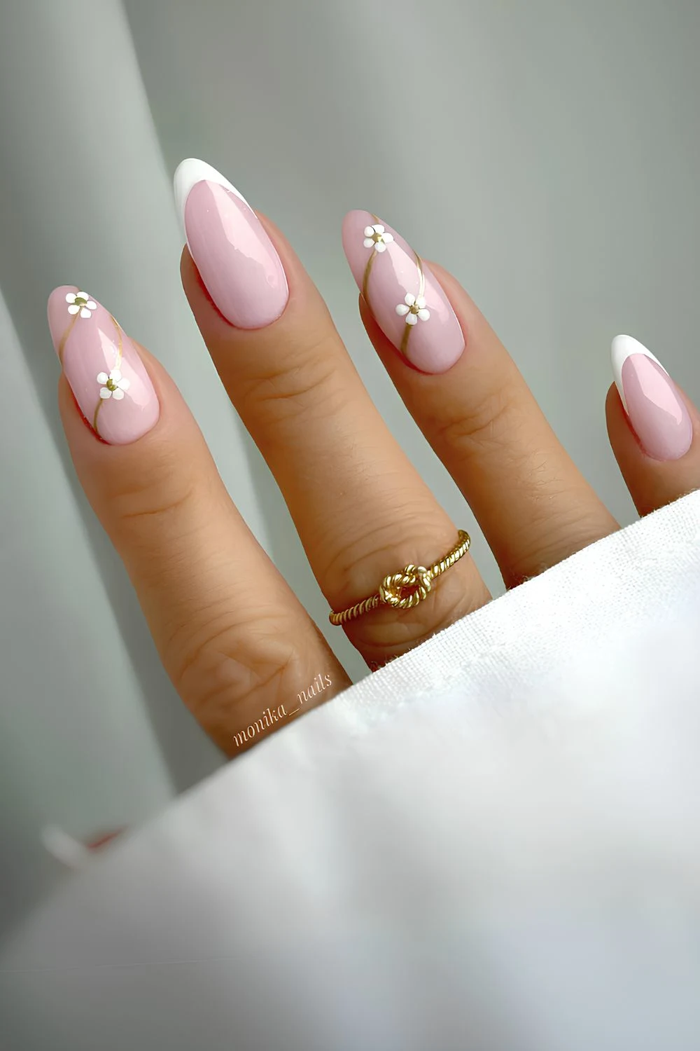 White floral French mani on a pink base