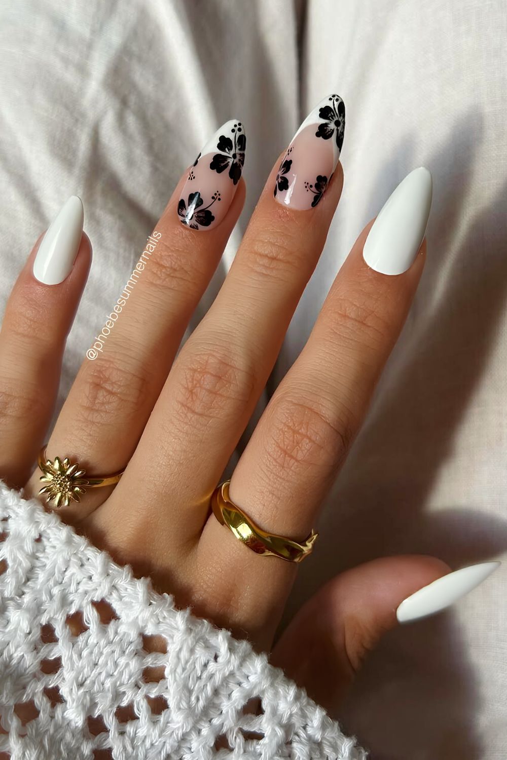  White nails with French tip accents and black hibiscus flowers