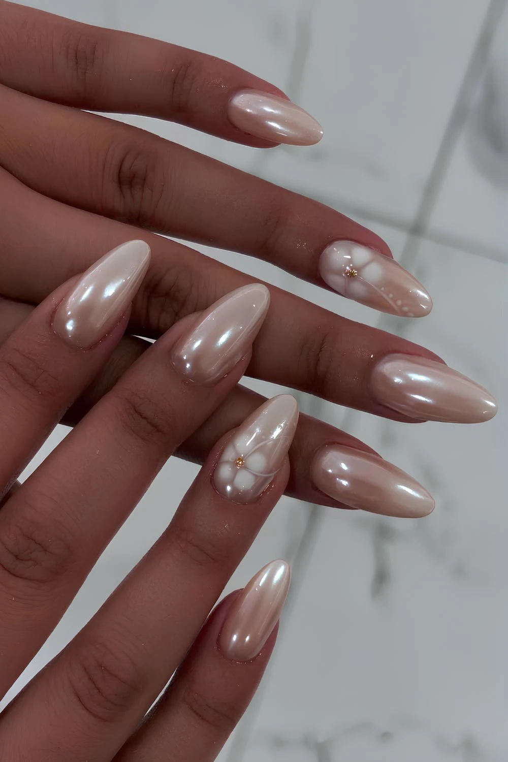 White pearl chrome nails with blooming flowers