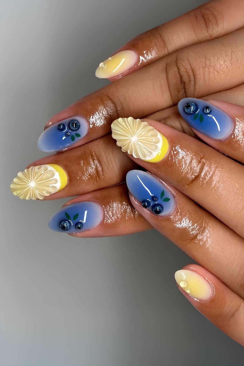 Blue and yellow nails with 3d lemon slice and blueberry accents