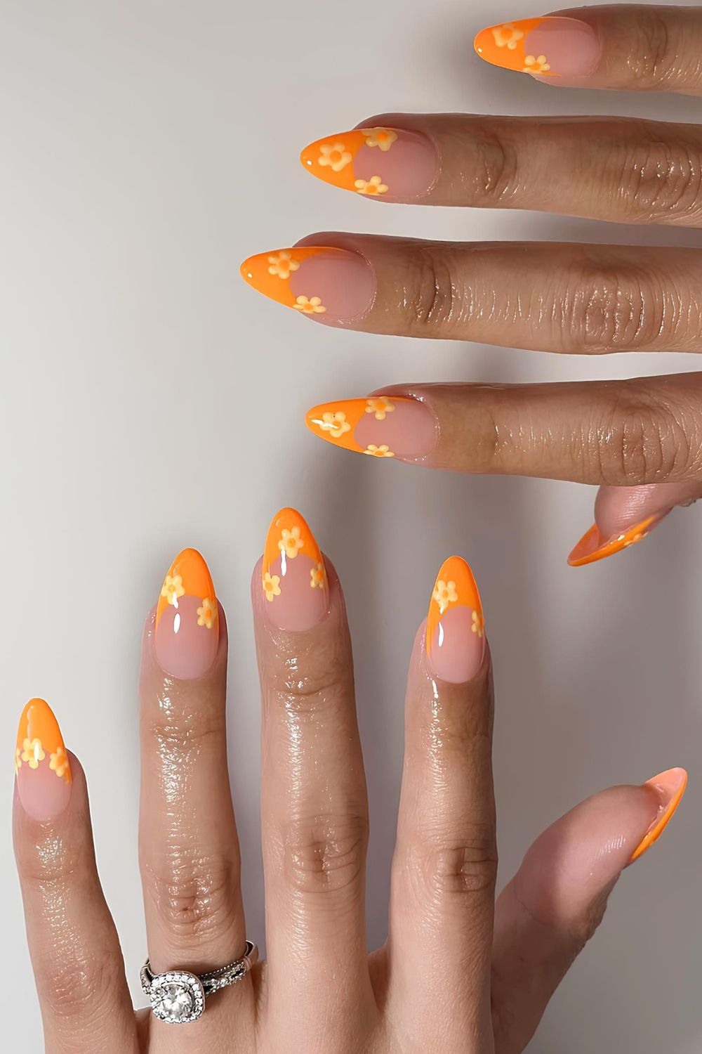 Bright orange French mani with yellow florals