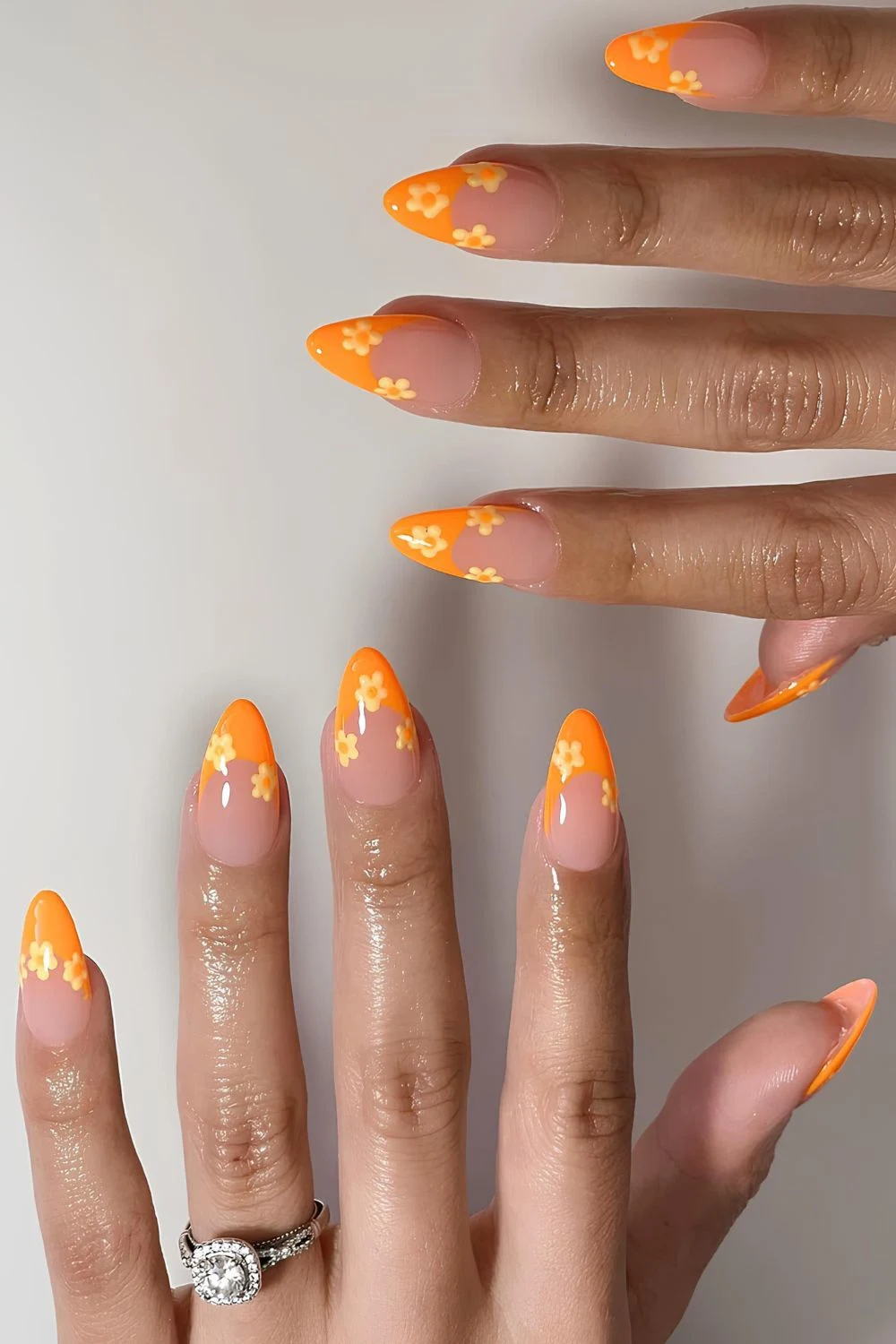 Bright orange French mani with yellow florals