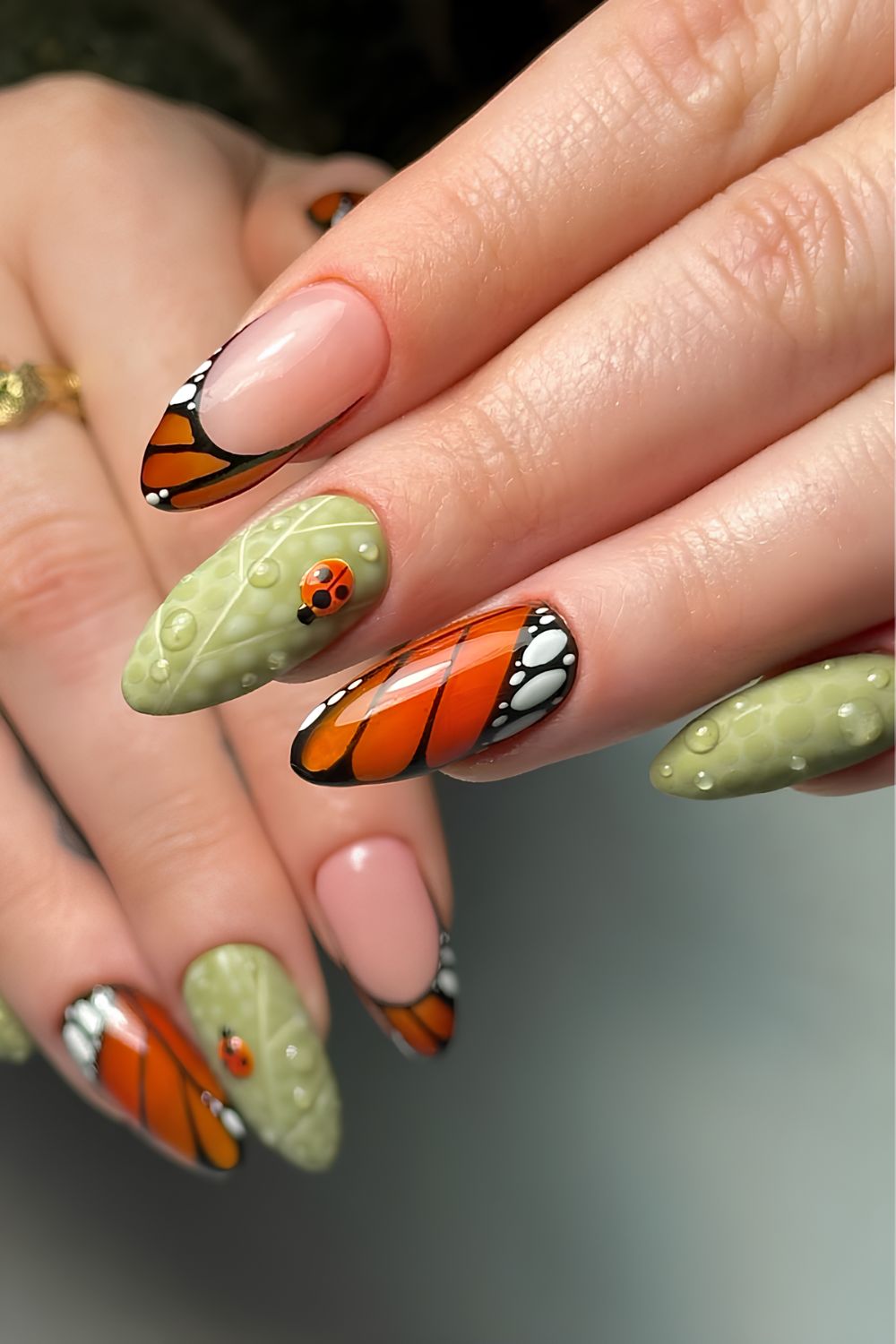 Butterfly and leaf nails with ladybugs and water droplets