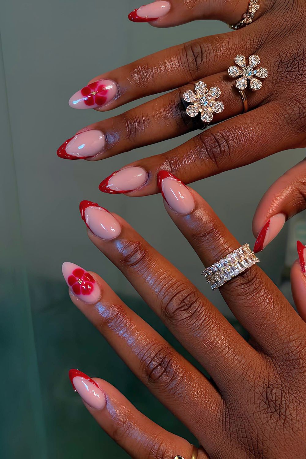 Cherry red French tips with raised swirls and blooming florals