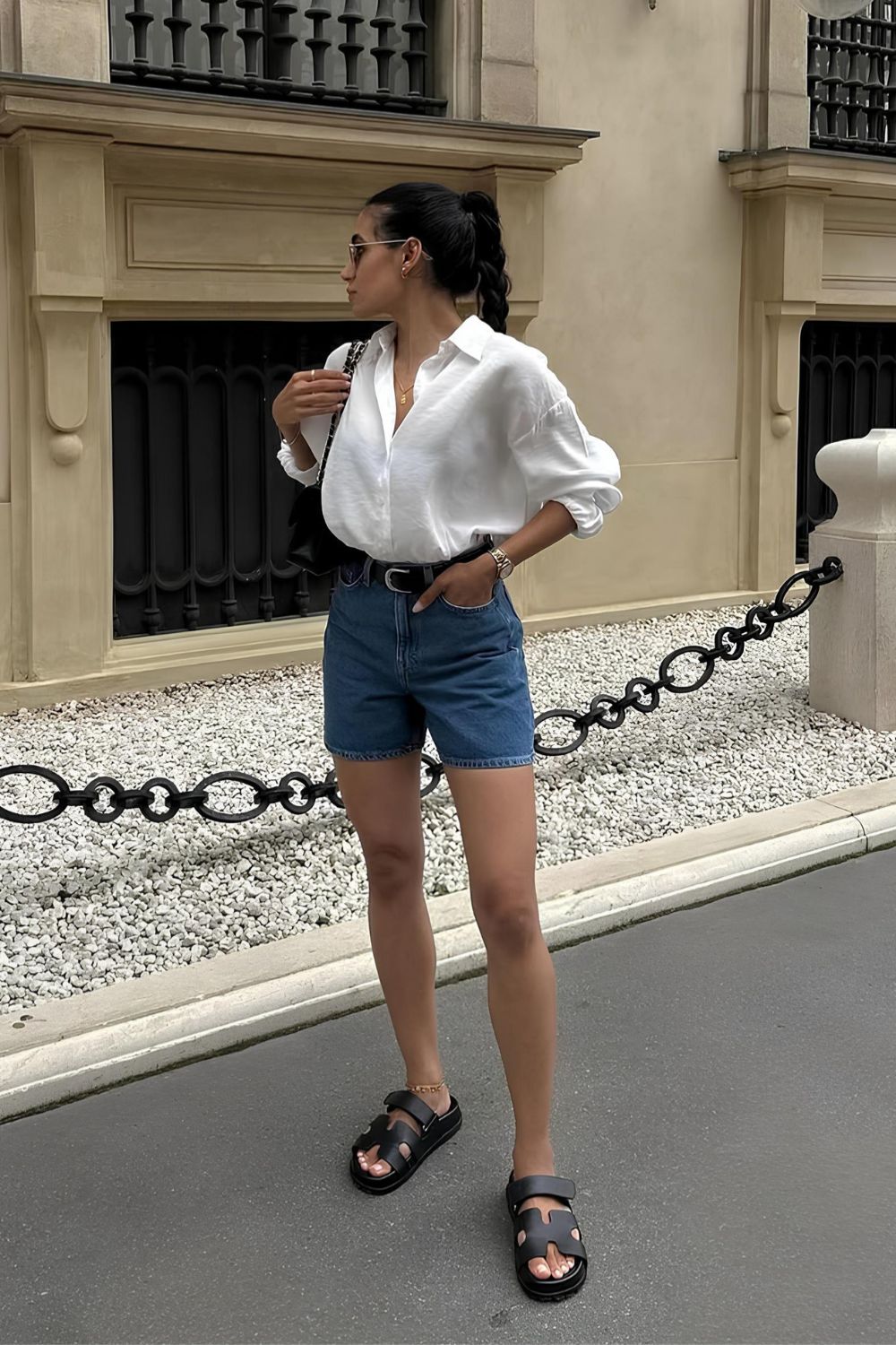 Denim shorts and white shirt and black sandals