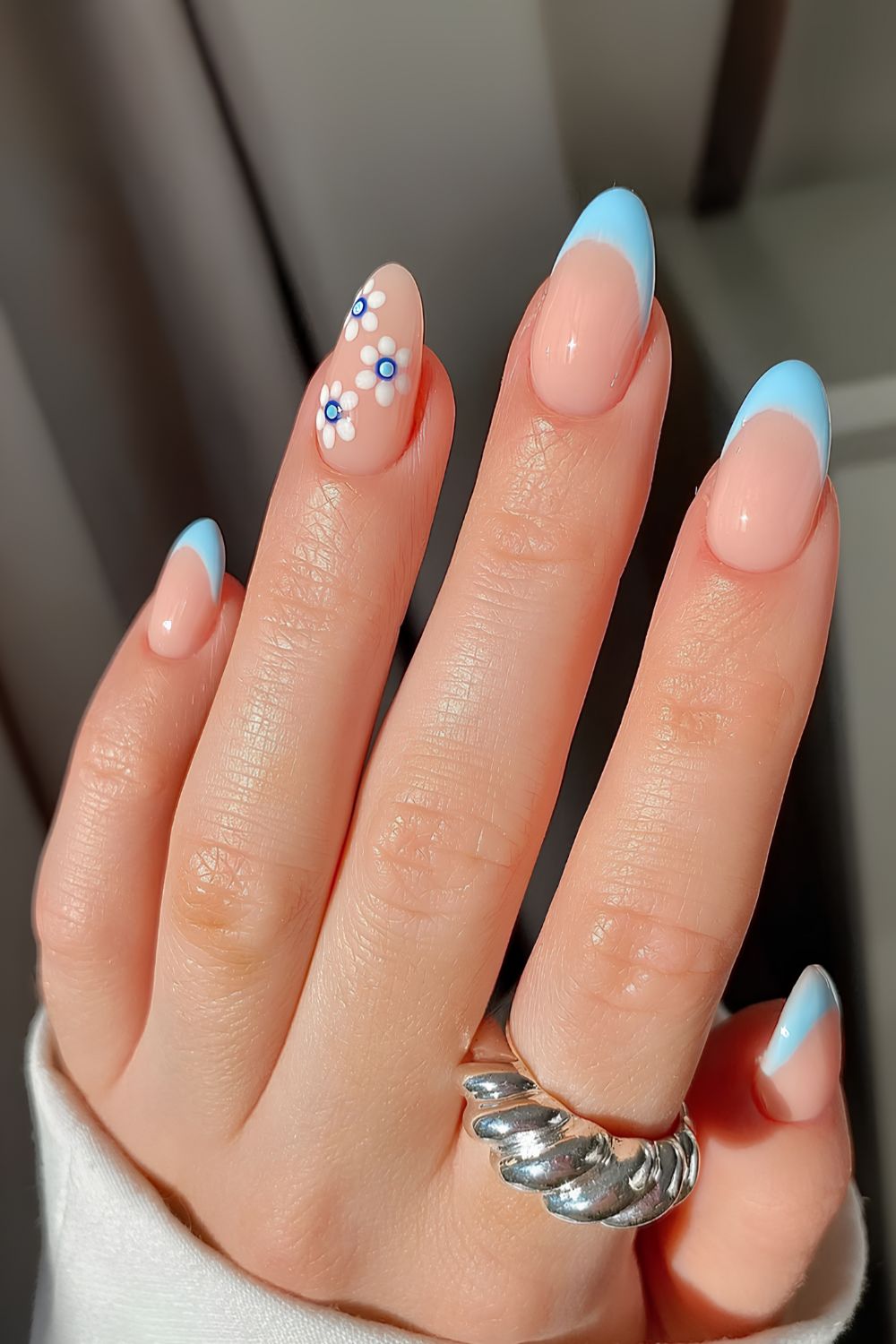 Light blue French manicure with floral art