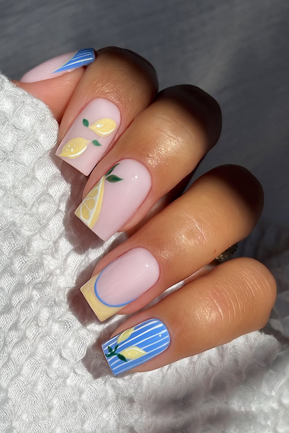 Milky base with blue striped and yellow frenchies and lemon motives