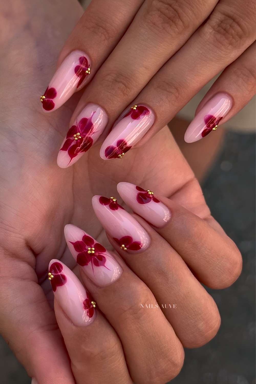 Milky pink nails with red blooming gel flowers
