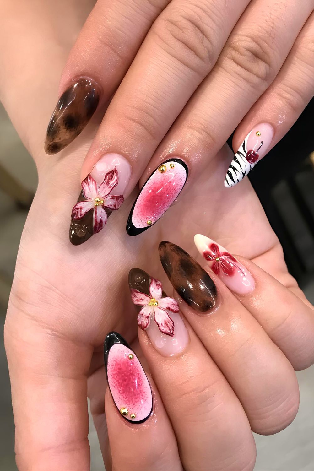 Mix and match nail design with sculpted florals, aura, French tip and animal print accents