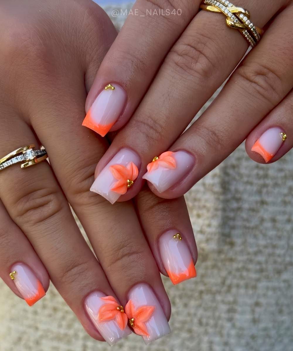 Neon orange French nails with 3d flowers