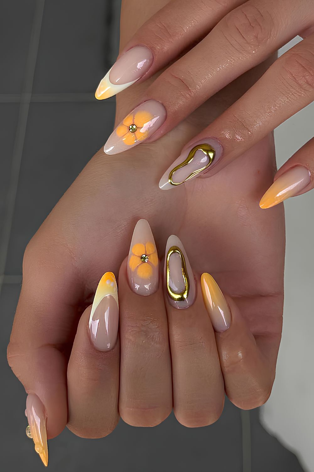 Orange nails with blooming gel flowers and chrome accents
