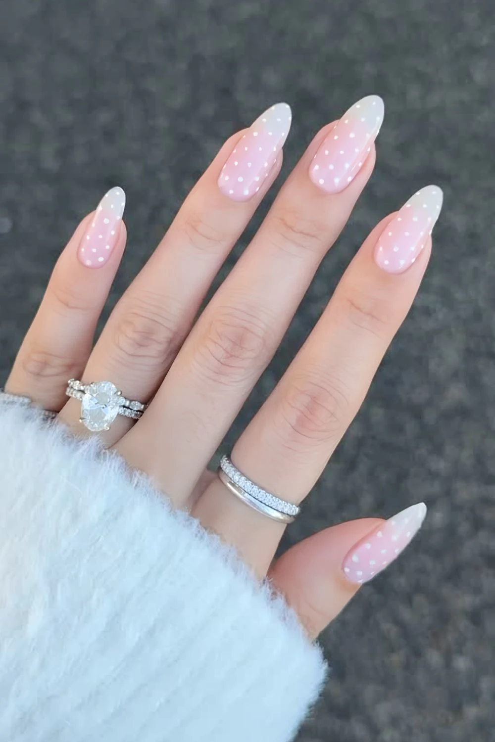 Pale pink base nails with white polka dots