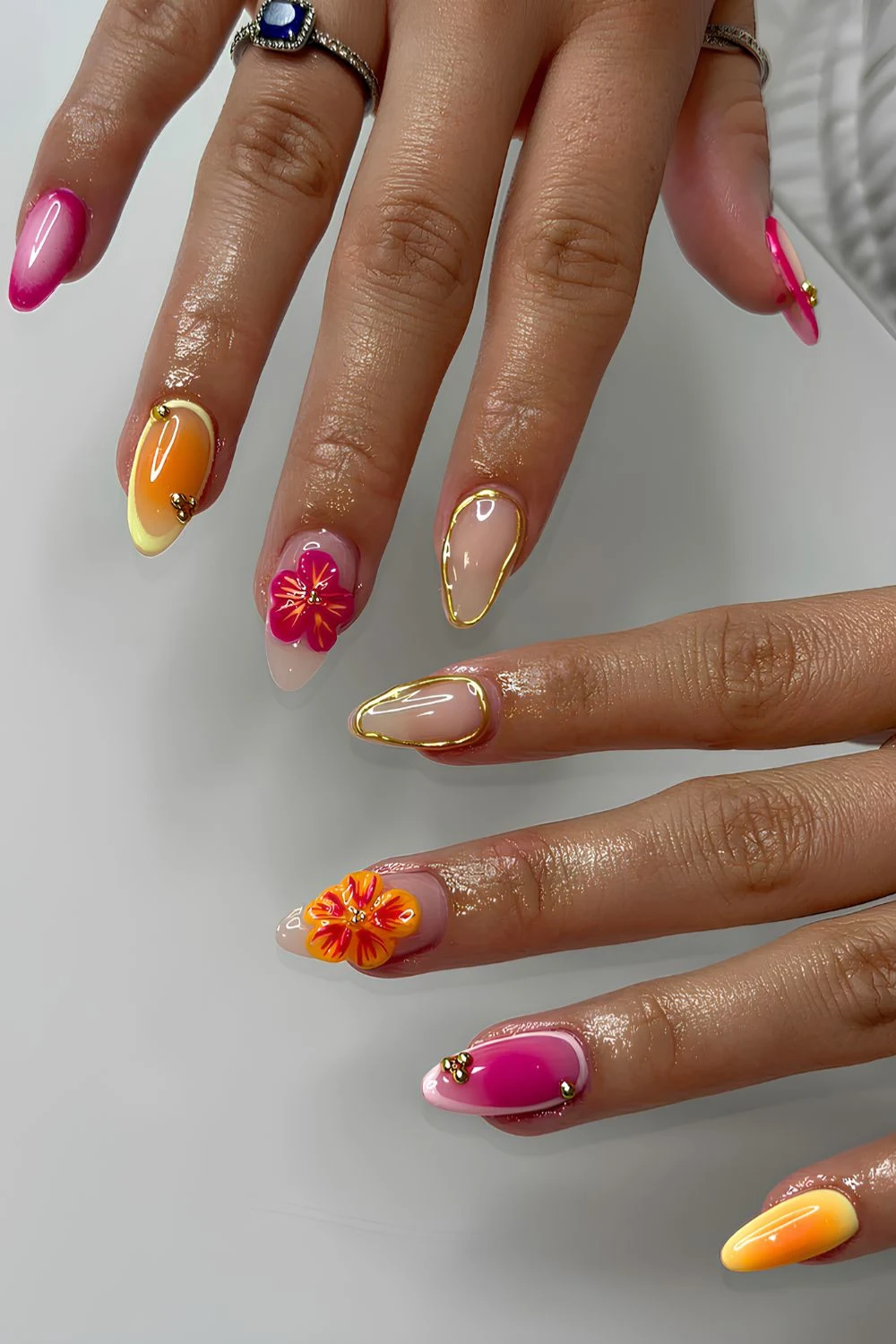 Pink and orange nails with 3d florals and gold chrome details