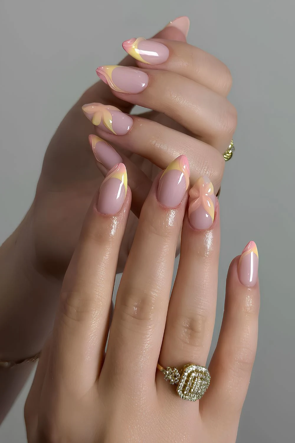 Pink and yellow French nails with textured flowers
