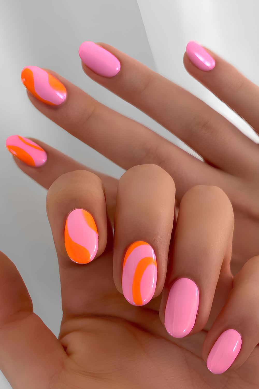 Pink nails with neon orange accents
