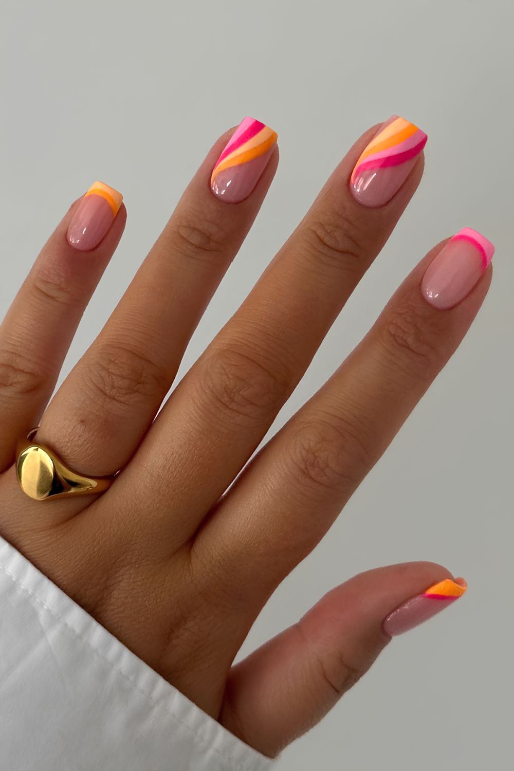 Pink orange and yellow nails with swirls