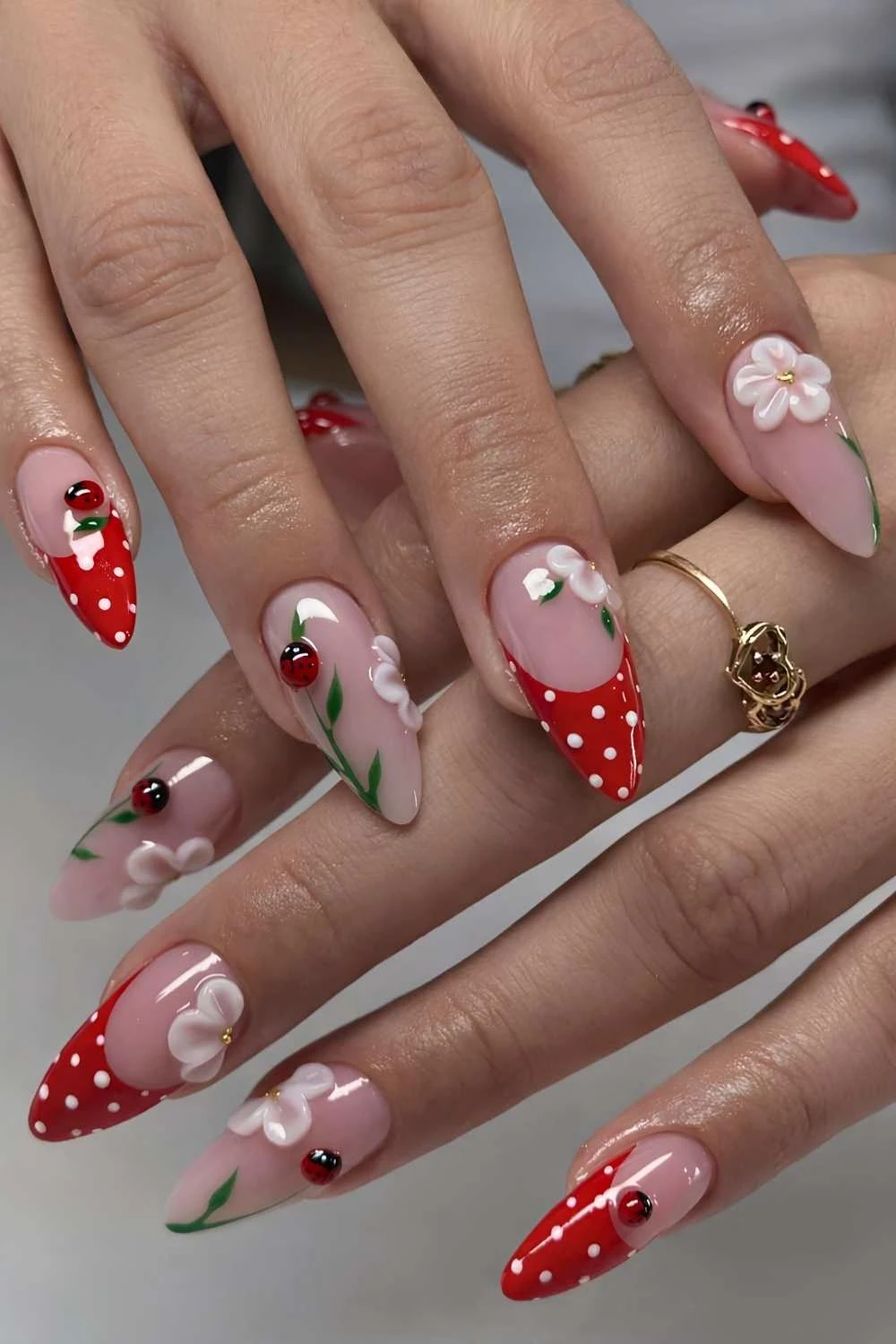Red French mani with 3d florals and ladybugs