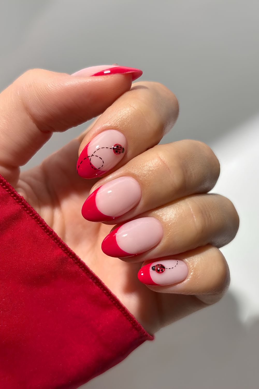 Red French tips with cat eye ladybug accents