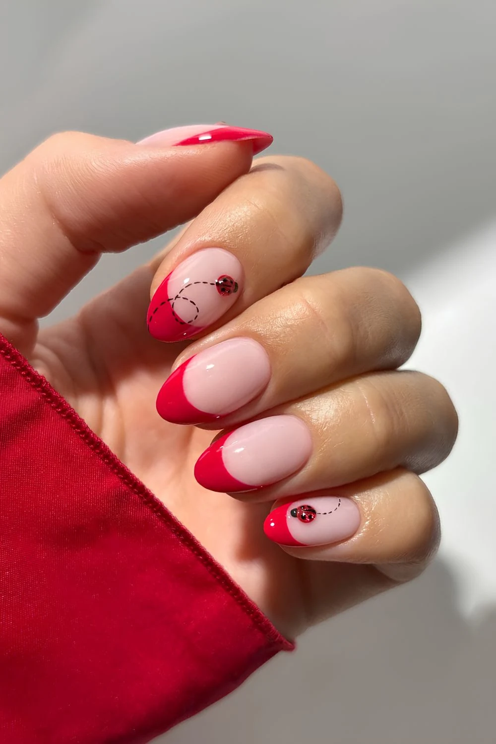 Red French tips with cat eye ladybug accents