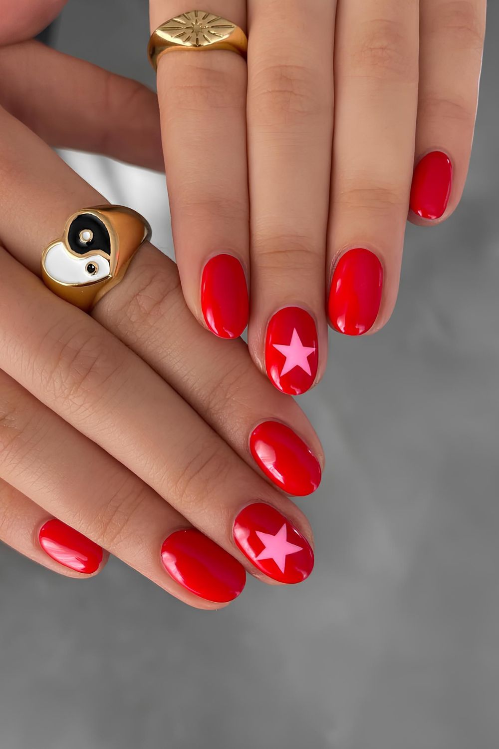 Red nails with pink star accent