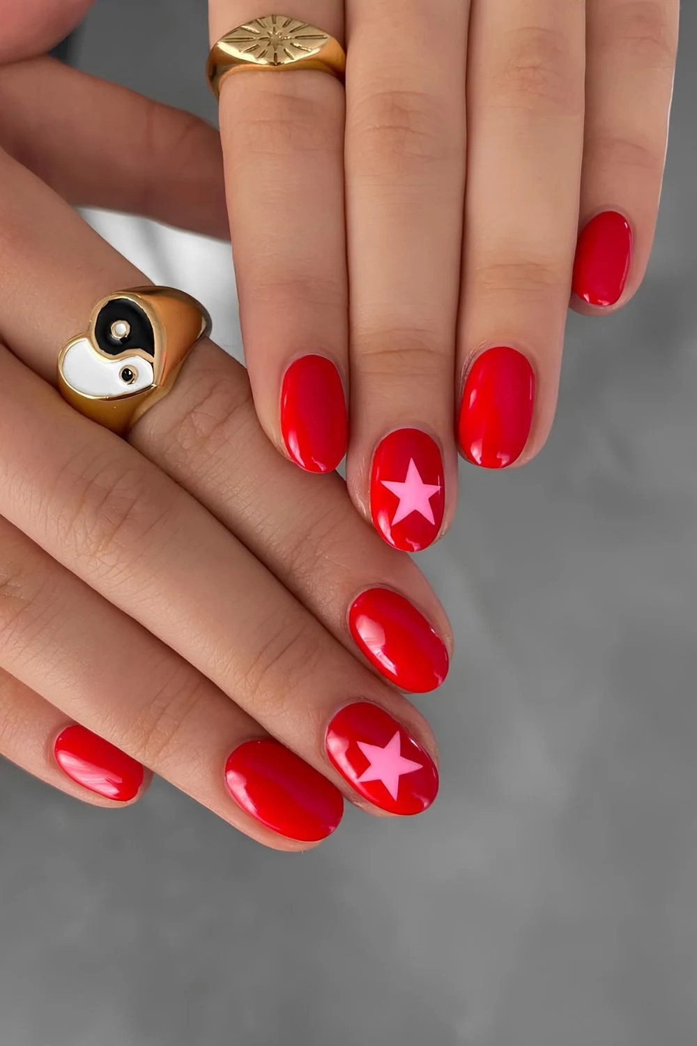 Red nails with pink star accent