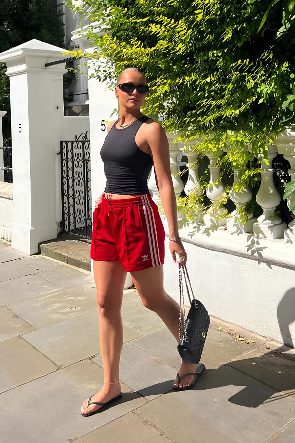 Red sporty short with black tank and flip flops