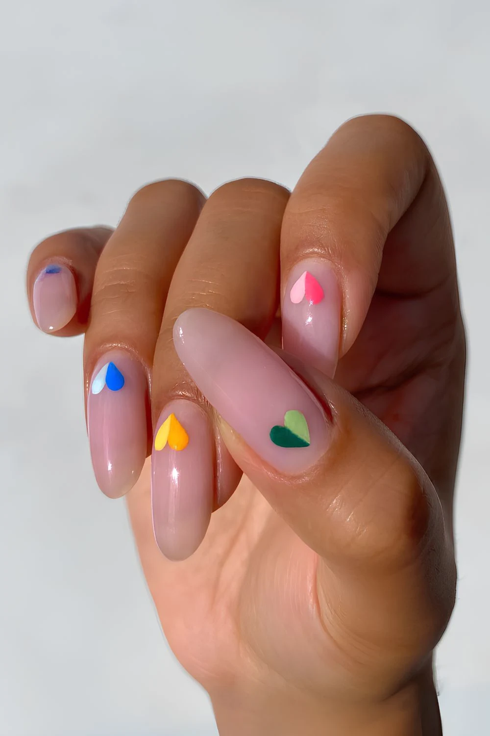 Two toned heart nail design on pink neutral base