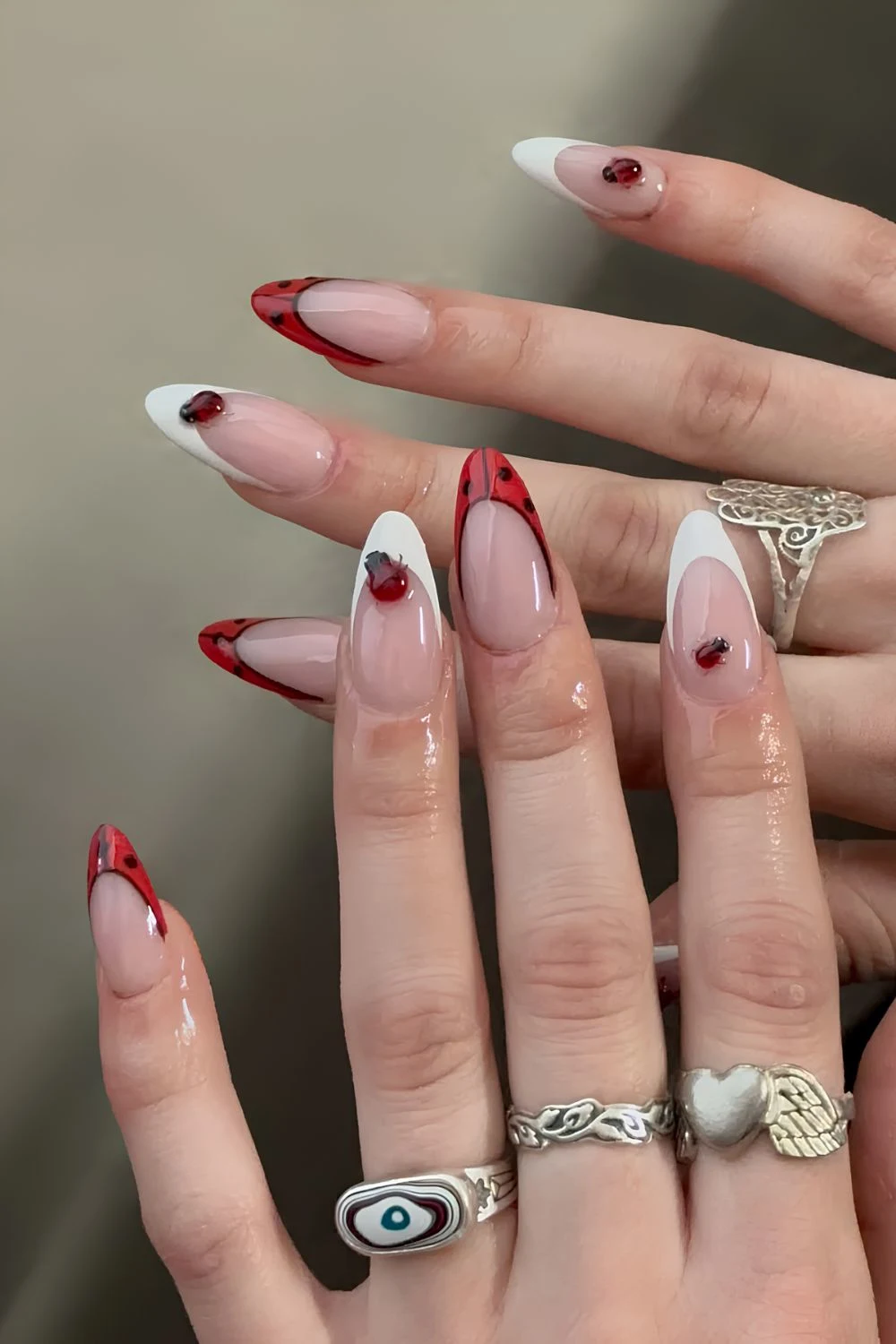 White and red French tips with black dots and 3d ladybug accents