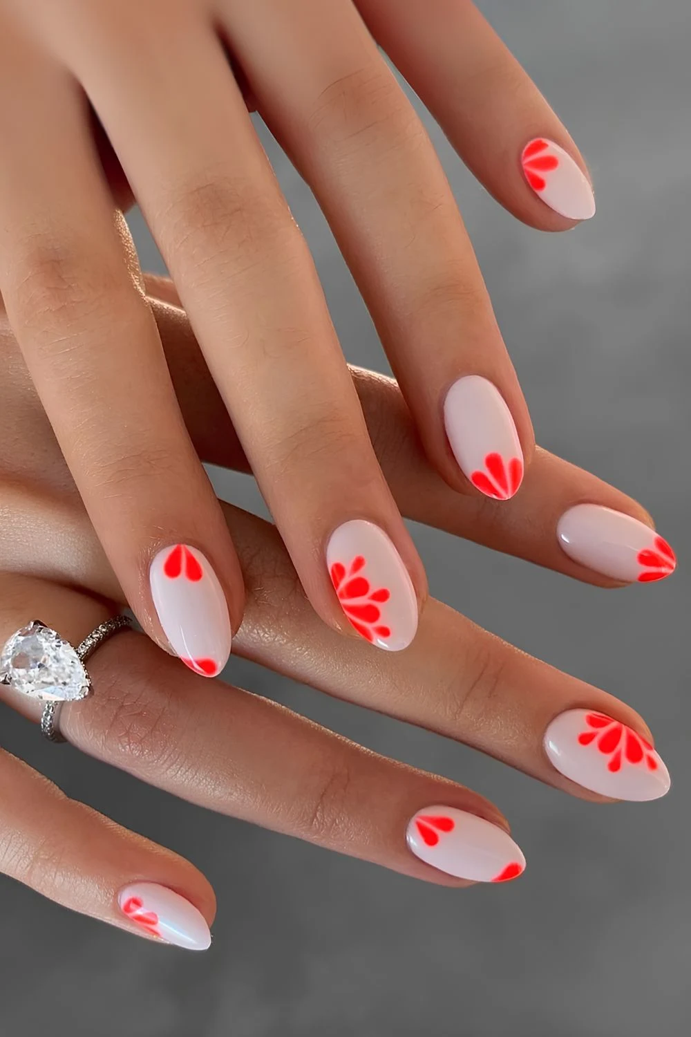 White manicure with neon coral floral art