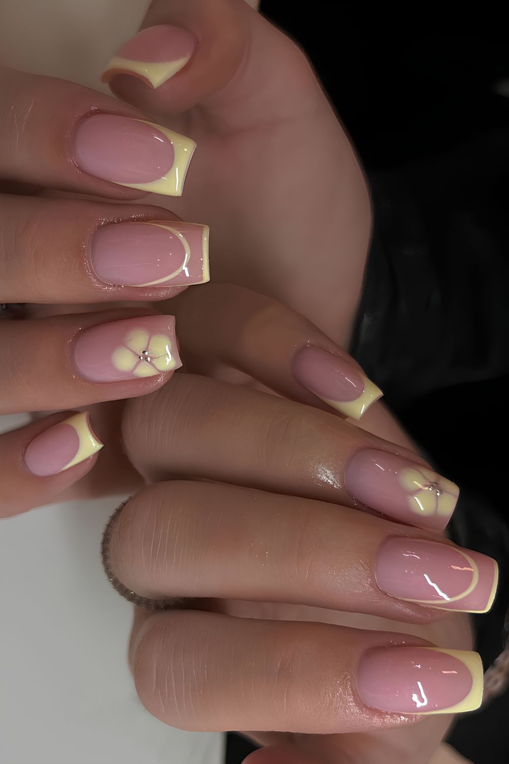 Yellow French nails with blooming gel flowers