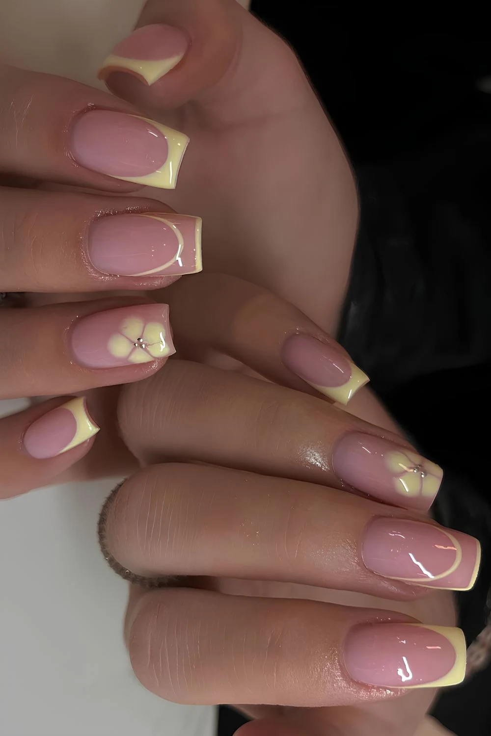 Yellow French nails with blooming gel flowers