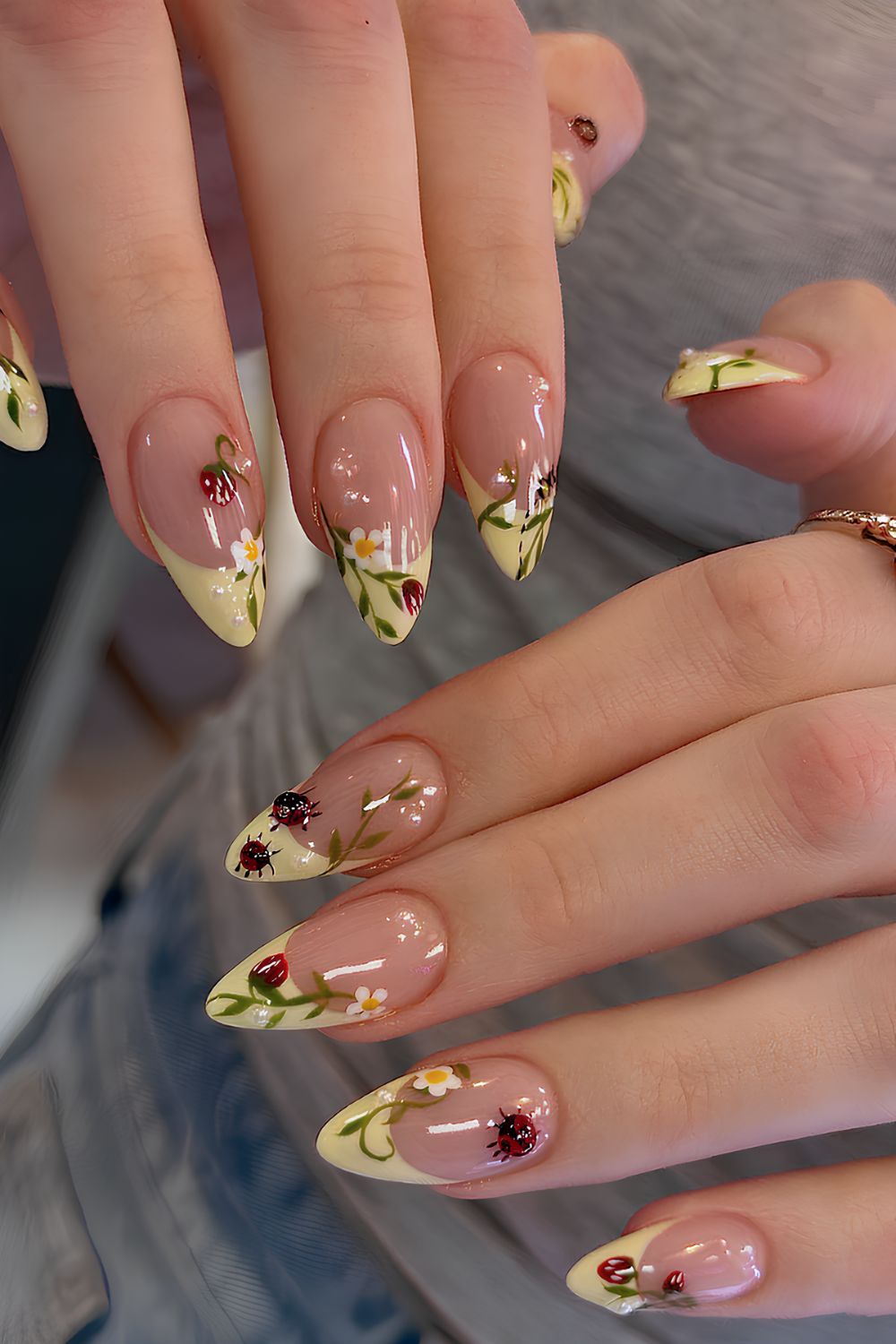 Yellow French tips with strawberry floral and ladybug design