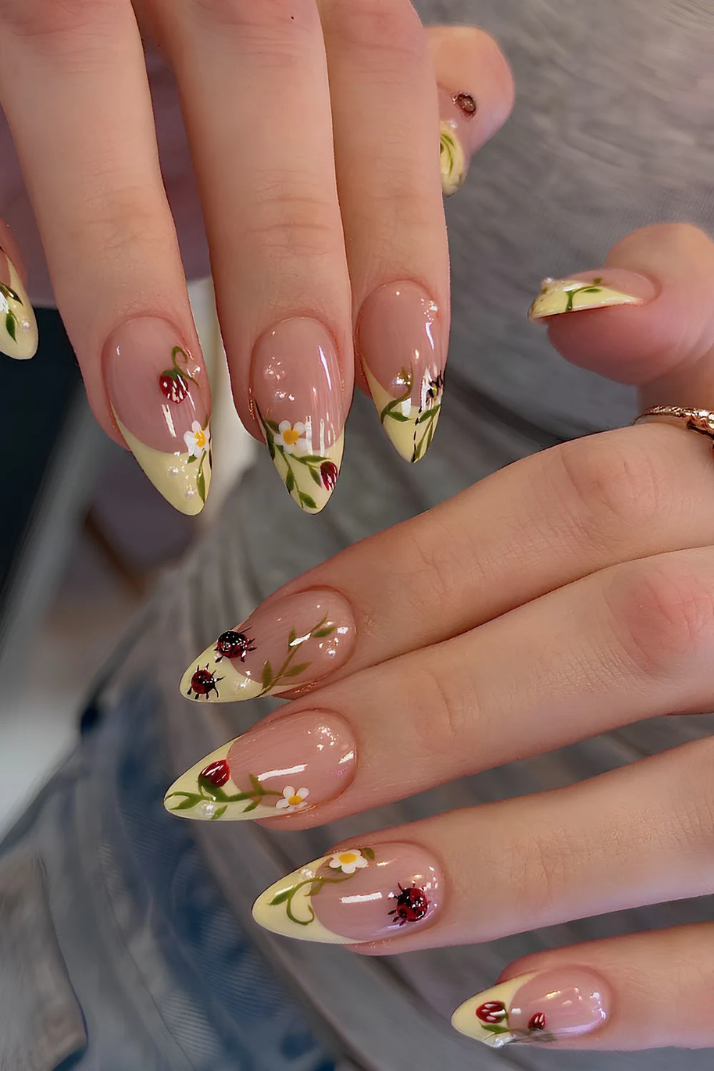 Yellow French tips with strawberry floral and ladybug design