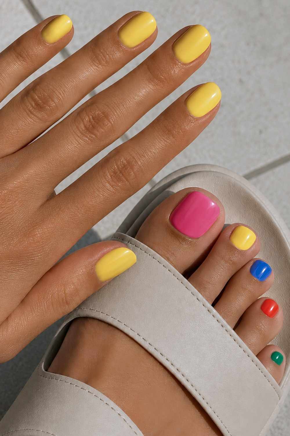 Yellow manicure and colorful pedicure