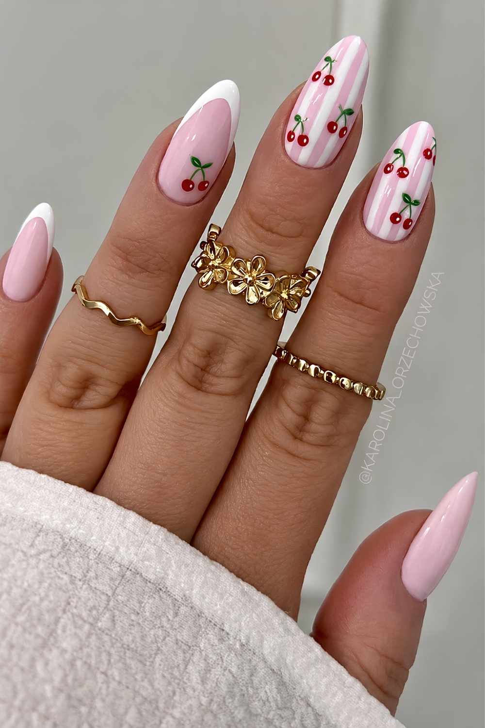 Almond pink and white nails with stripes and cherries