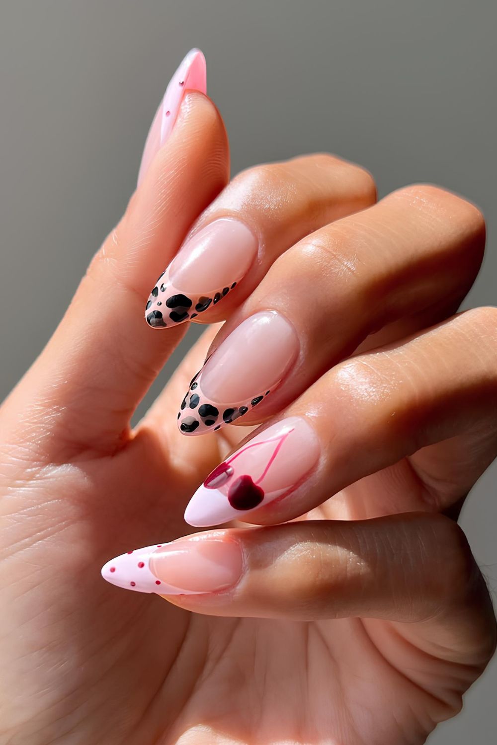 Animal print French mani with dotted tips and cherry accent