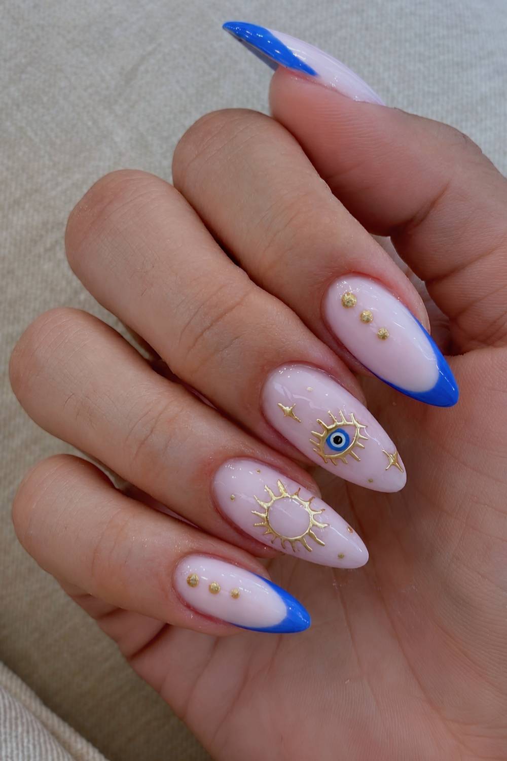 Blue French mani with evil eye and gold art work