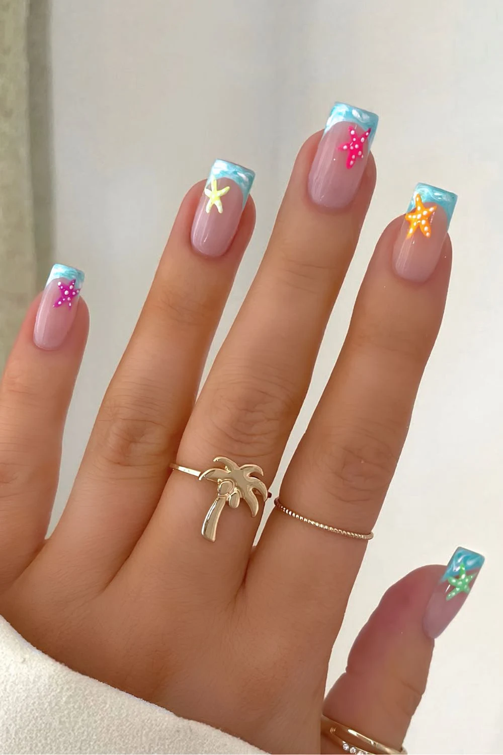 Blue marble french tips with neon starfish motives