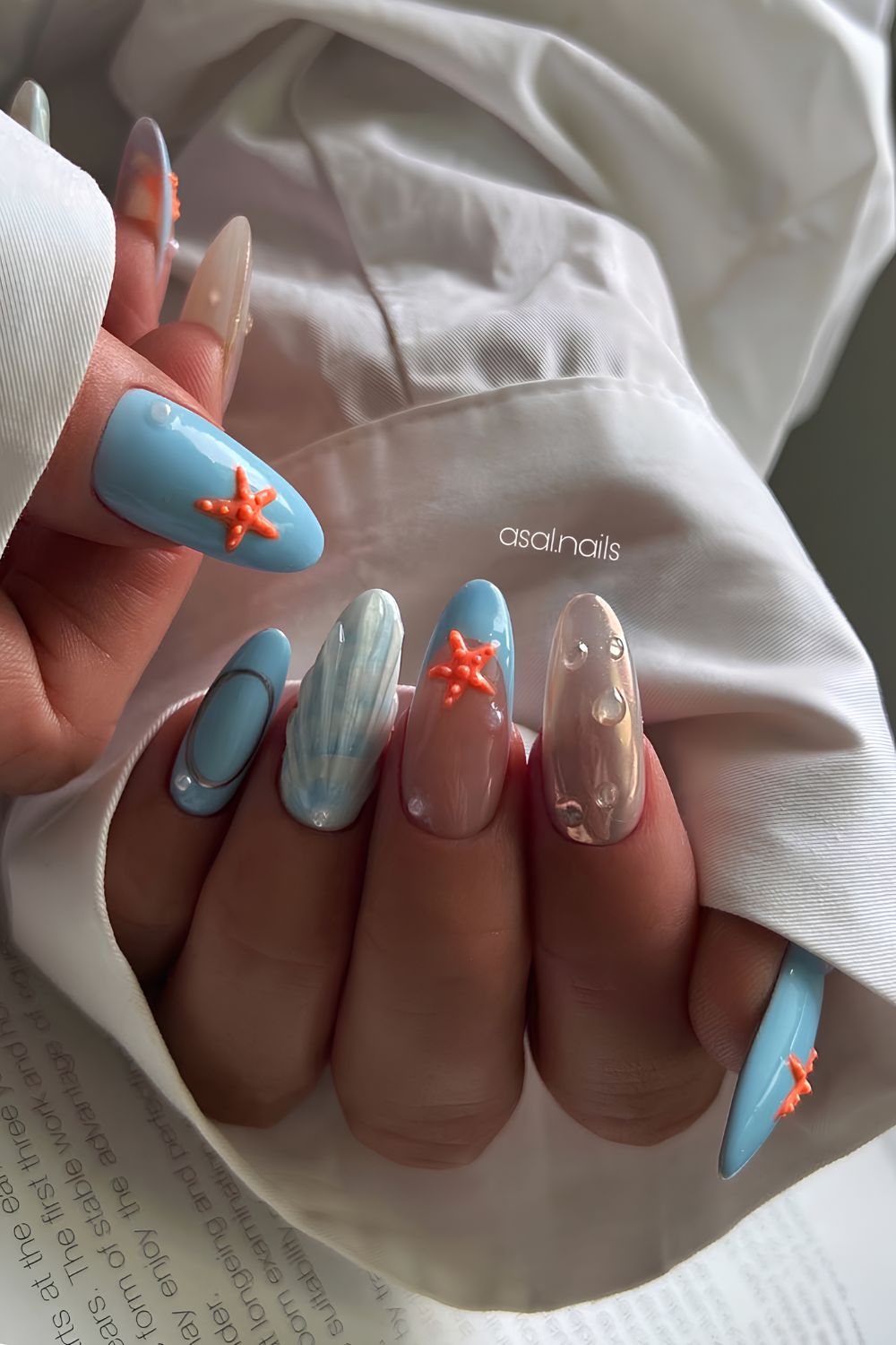 Blue nails with seashell and orange starfish design
