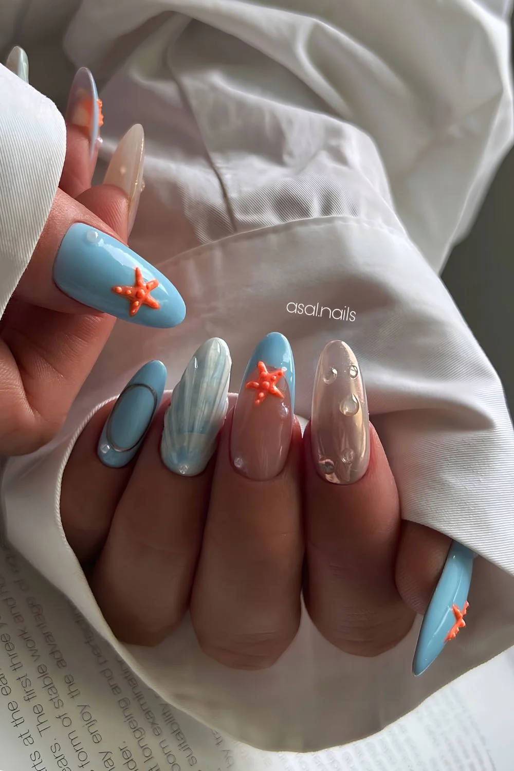 Blue nails with seashell and orange starfish design