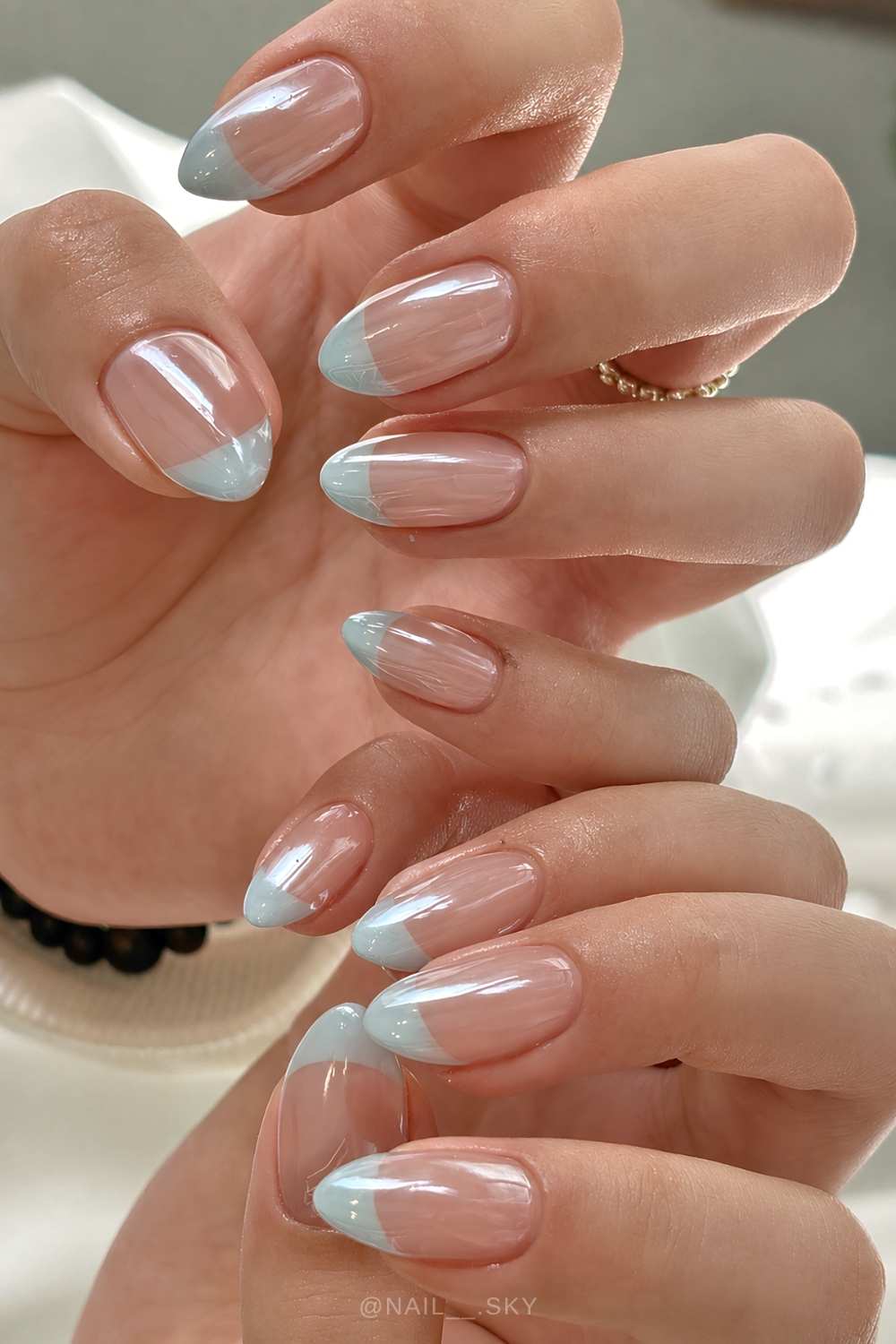 Chromed light blue French manicure