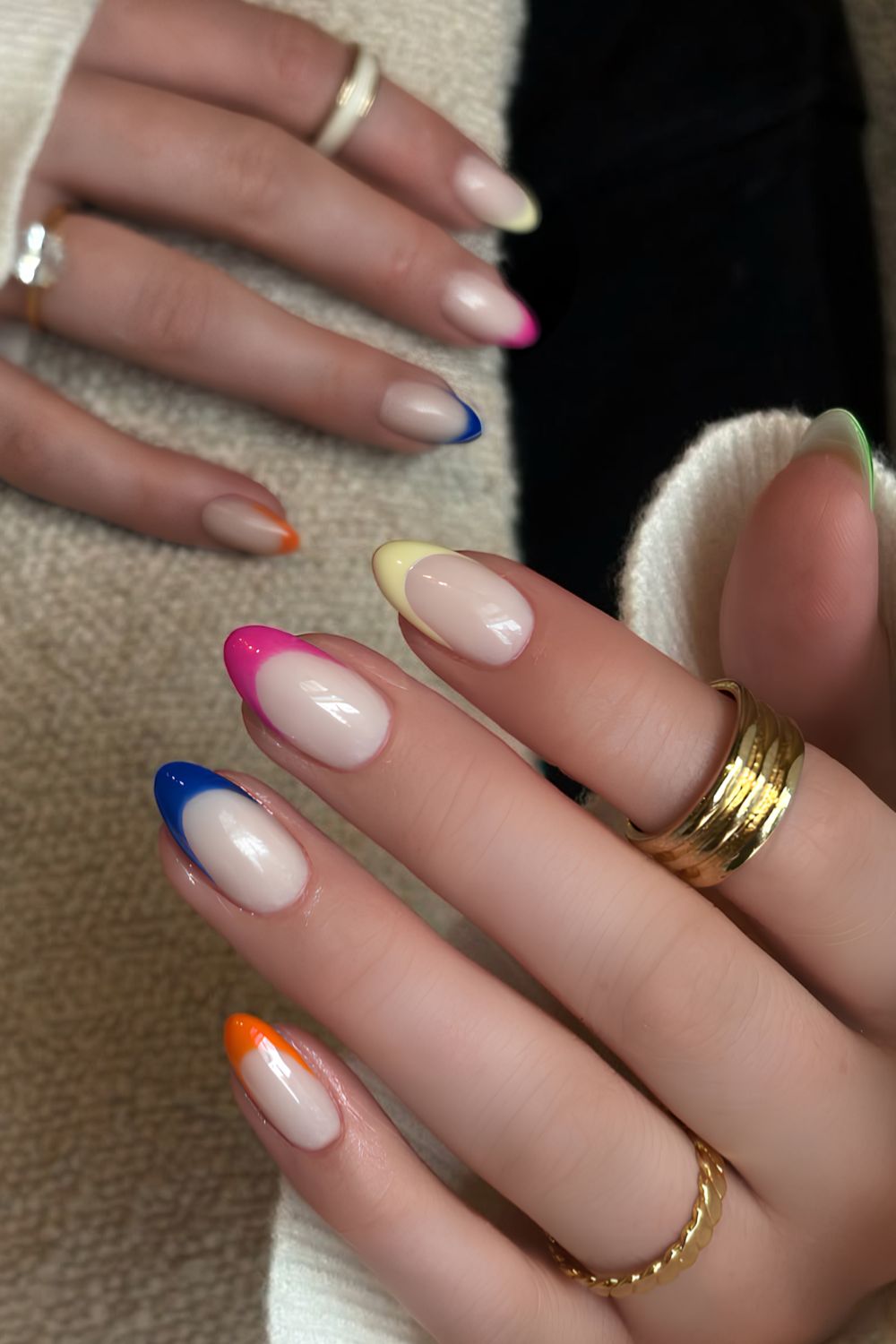 Colorful French tip manicure on a milky white base