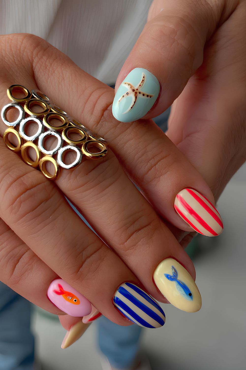Colorful nails with stripes and beach-themed art