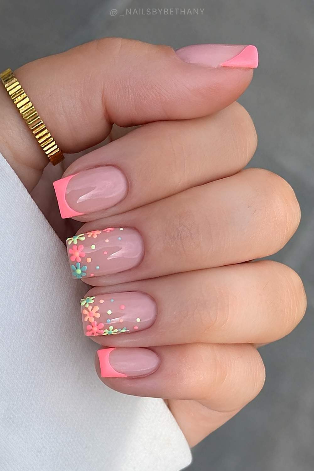 Coral French nails with colorful floral art