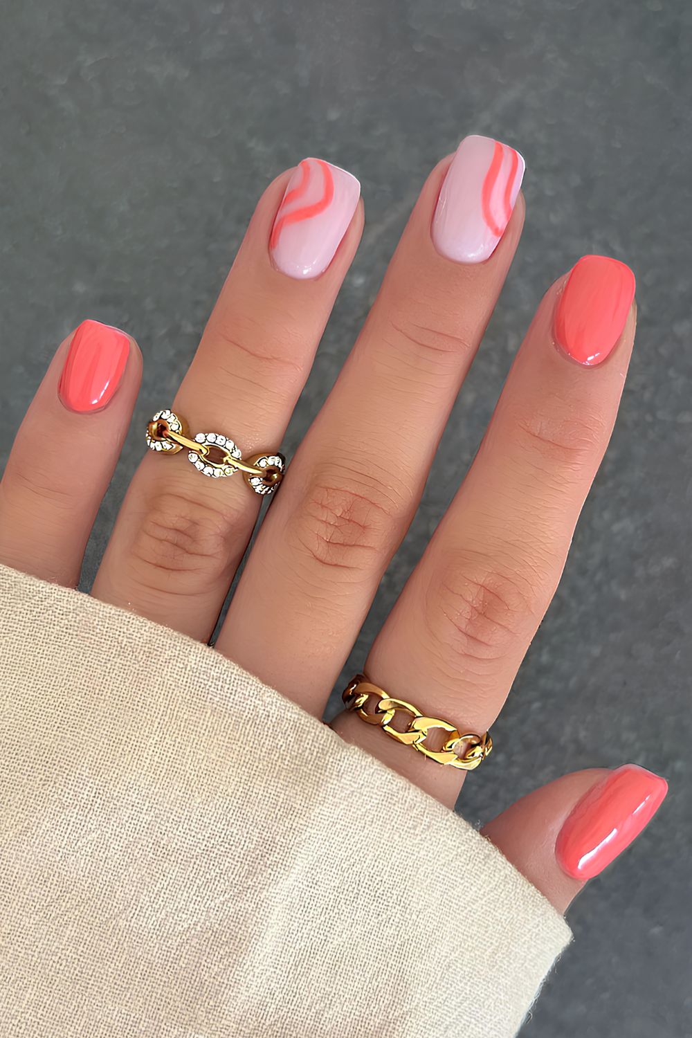 Coral nail design with swirls