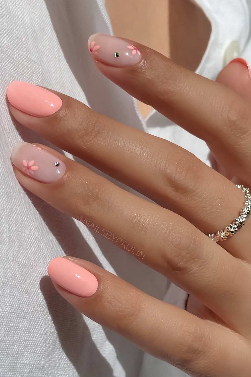 Coral pink nails with flowers and gems