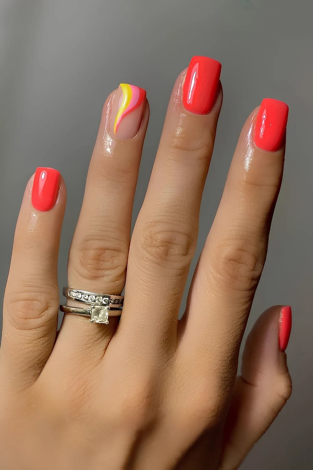 Coral red nails with stripe accents