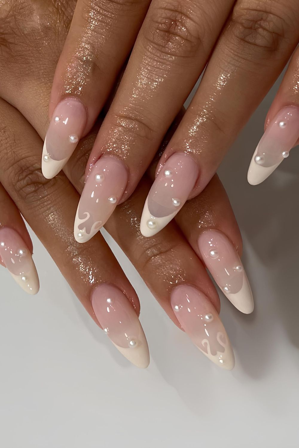 Creamy white French mani with swirls and pearls