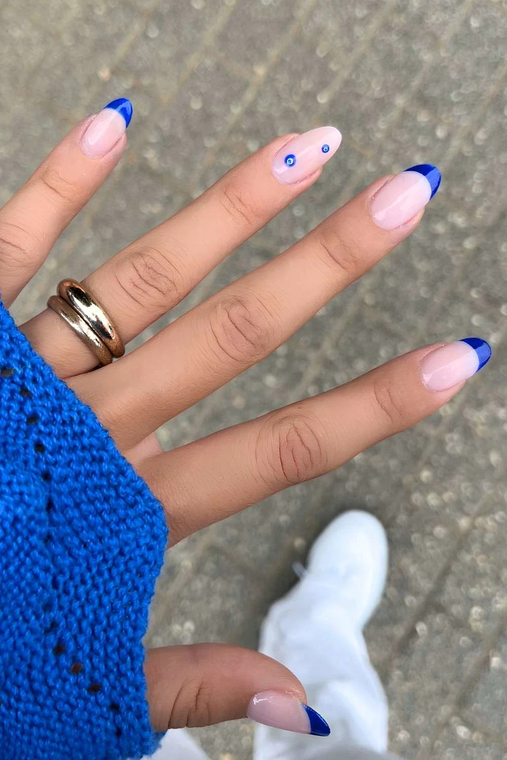 Dark blue French tips with evil eye accent nails