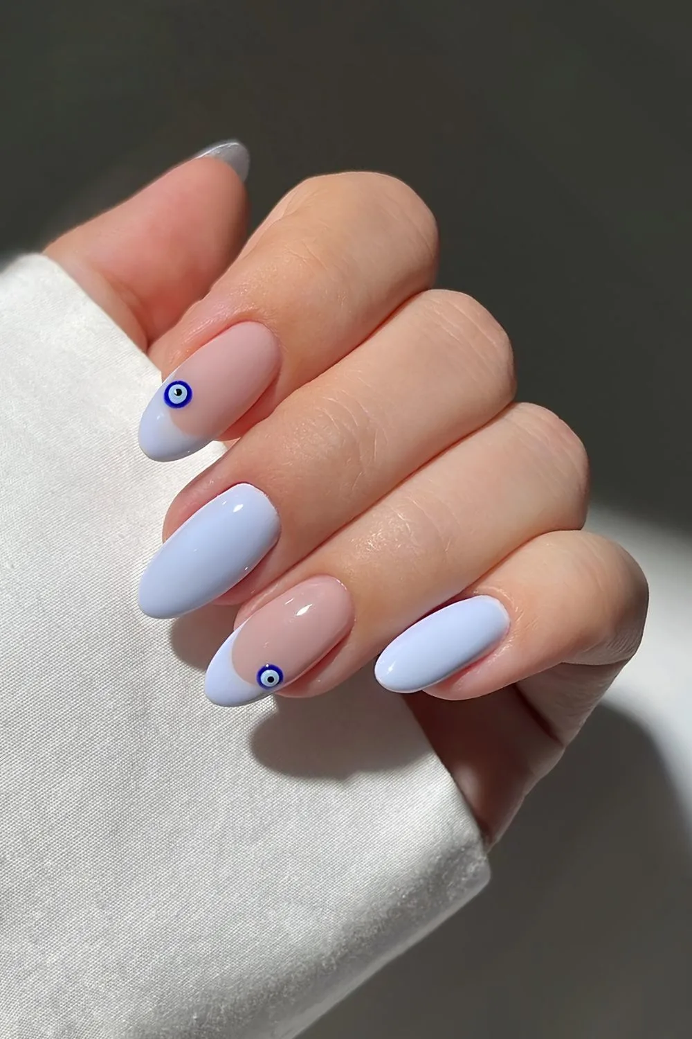Light blue French and solid nails combo with 3d evil eye decals
